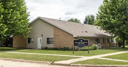 A house with a sign in front that says "Welcome to Maple Shade".