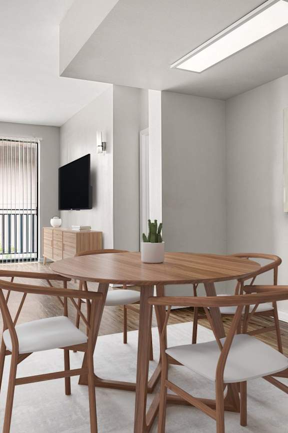 A dining room with a wooden table and chairs.