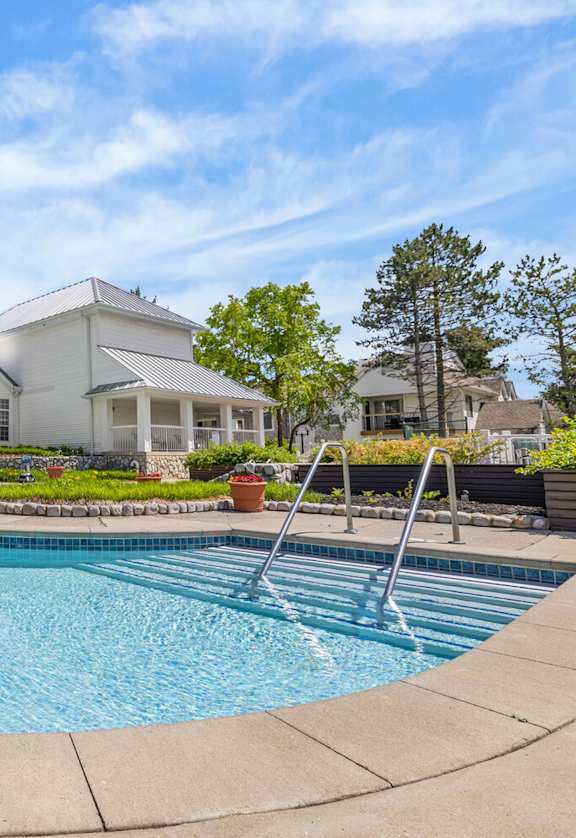A large house with a pool in the backyard.