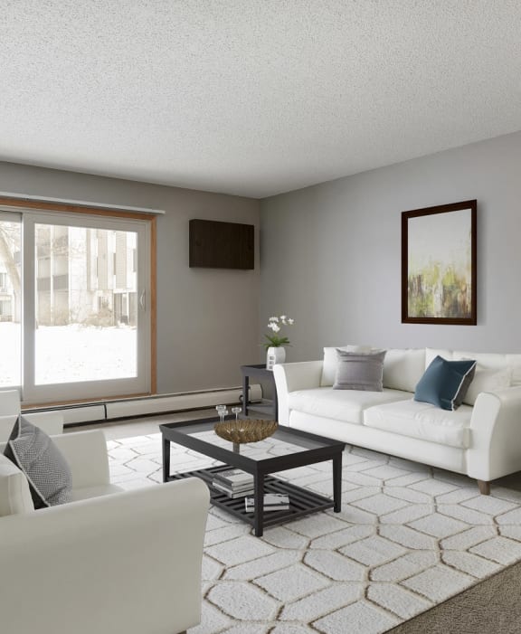 a living room with white furniture and a large window  at Pebblebrook Flats, Bloomington, MN