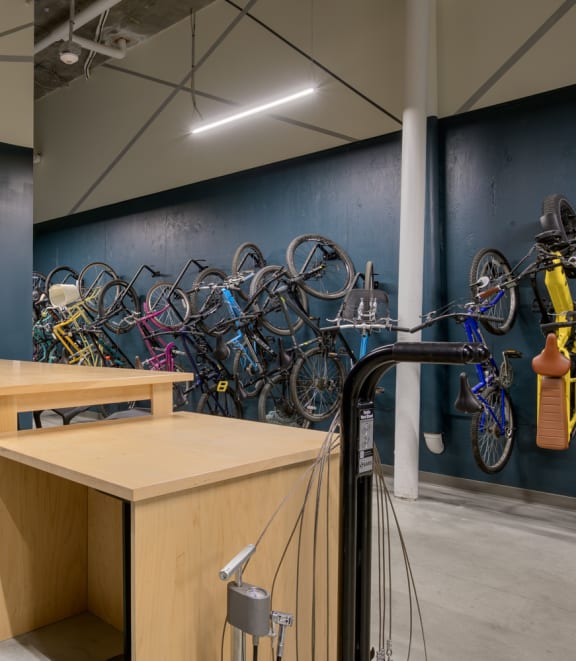 the new store is filled with bikes and a table with a tv at The Lucy Boise Apartments, Boise, Idaho