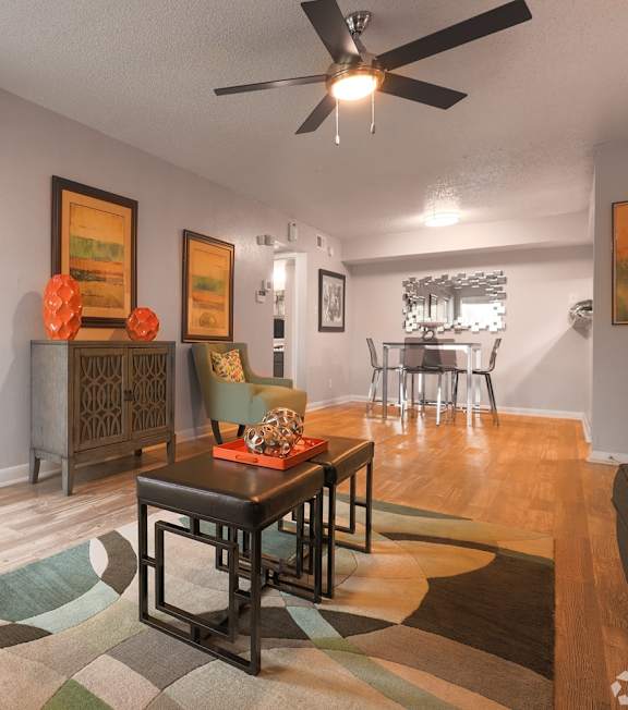 A living room with a brown table and chairs.
