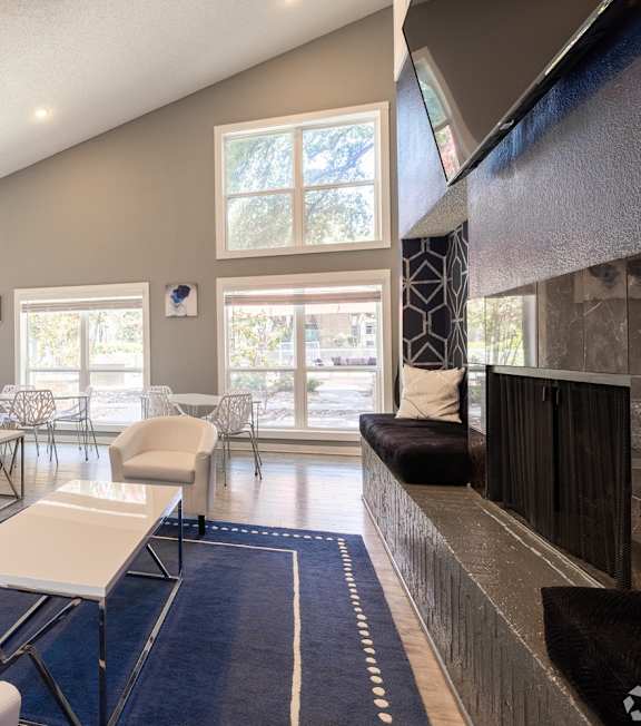 A living room with a grey couch and a white coffee table.