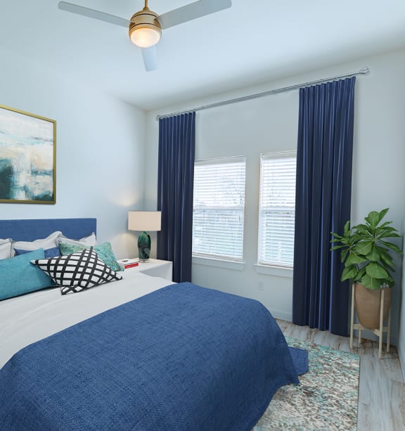 a bedroom with blue and white walls and a blue bedspread