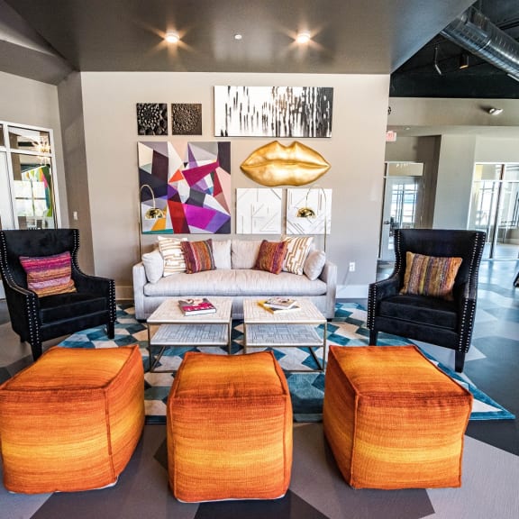 a living room with a white couch and orange chairs  at The Collective NoDa, Charlotte, 28205