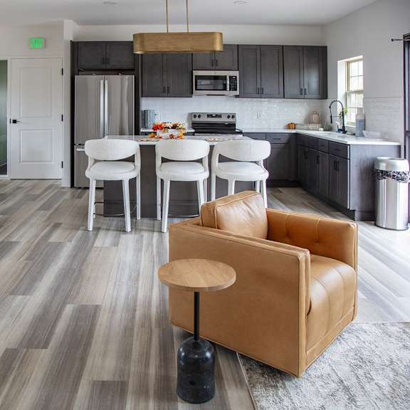 A modern kitchen with a dining table and chairs at Evergreen Luxury Apartments, Merrillville, 46410
