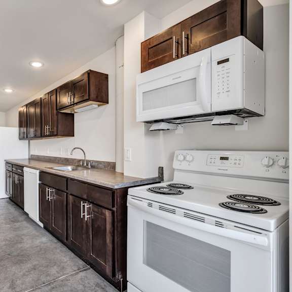 a kitchen with white appliances and wooden cabinets