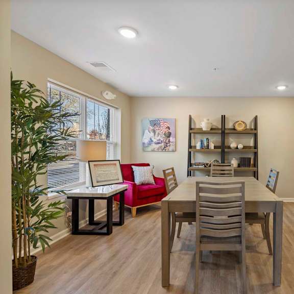 a dining room with a table and chairs and a sink