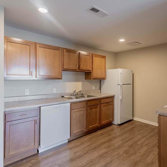 a kitchen with wooden cabinets and a white refrigerator