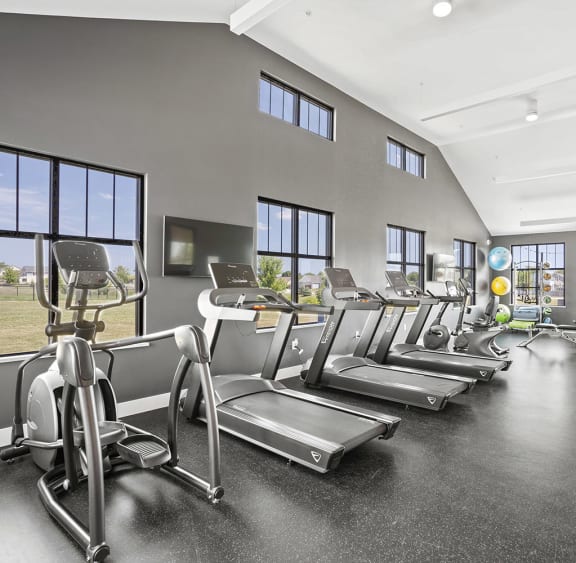 the gym has cardio equipment and treadmills at the flats at west end apartments at Tivoli Green Apartments & Townhomes, Mount Pleasant, Wisconsin