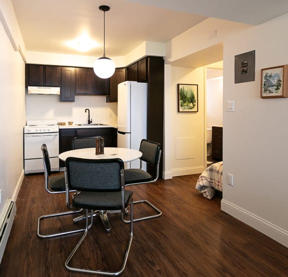 a bedroom with a bed and bookshelves     and a chair