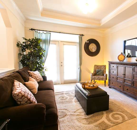 a living room with a couch and a dresser at The Park at Monterey Oaks, Austin, Texas