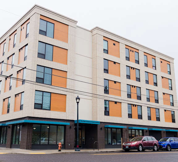 A modern building with a mix of orange and beige panels.