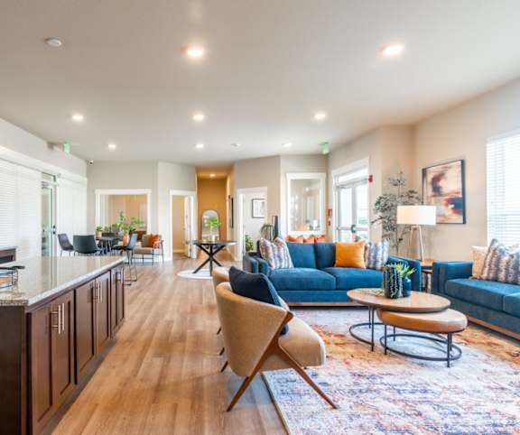 A modern kitchen with a dining area and living room.