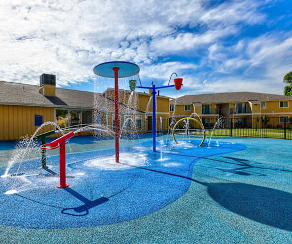 The outdoor water park with water fixtures at Indigo Apartments. 
