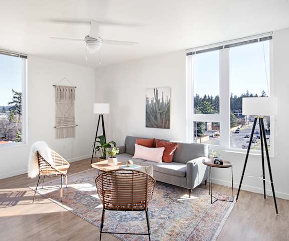 A living room with a grey couch, a chair, and a table.