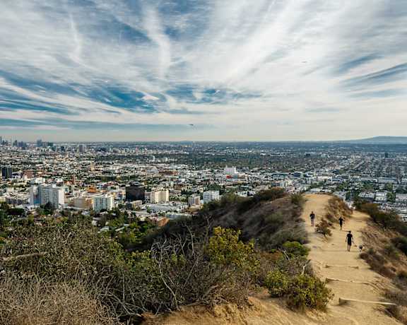 people walking up a hill overlooking the city The Baxter in Los Angeles, CA 90028