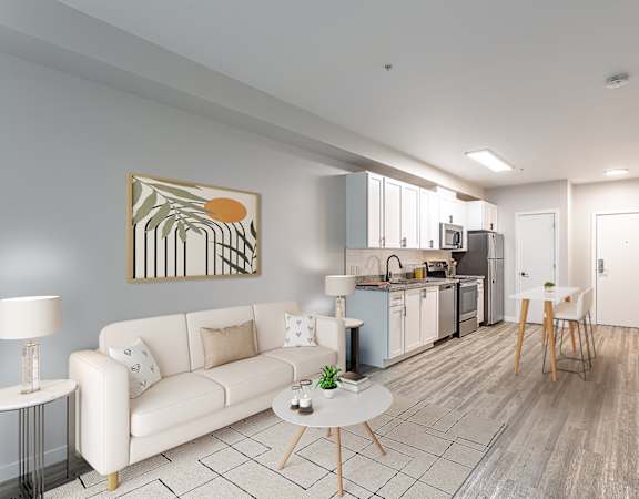 a living room with a couch a table and a chair and a kitchen with a stove and