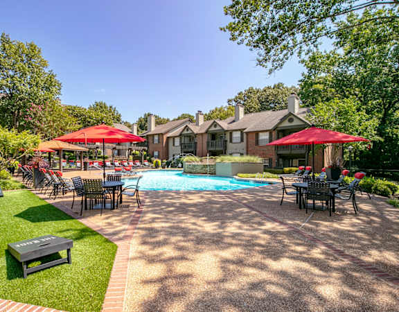 Pool deck with umbrellas and cornhole at The Edge of Germantown, Memphis, TN