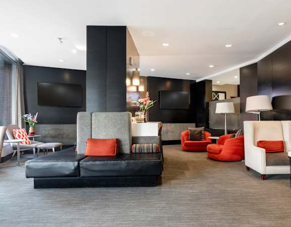 a living room with couches and chairs and a television