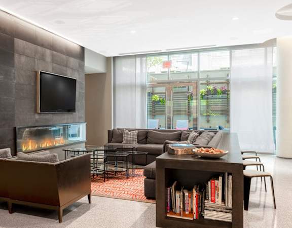a living room with a fireplace and a television