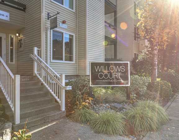 the exterior of willows court with a sign that reads willow court
