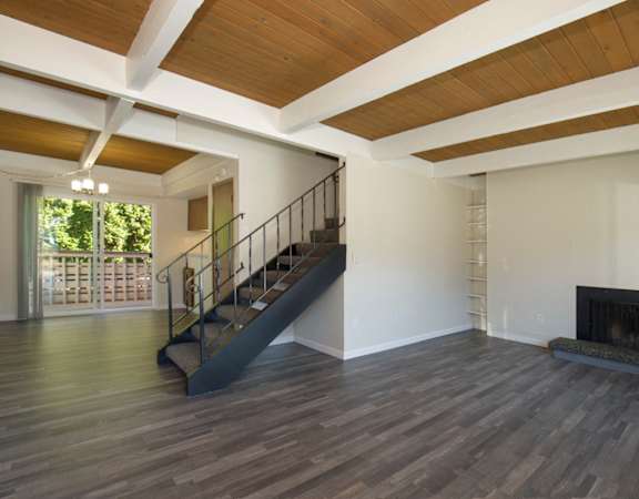 a large living room with hardwood floors and a fireplace