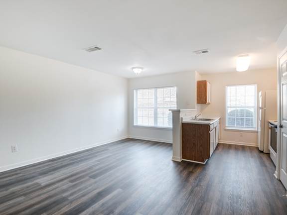 A kitchen with white appliances and wooden cabinets. at The Regency Apartment Homes, Manassas, VA