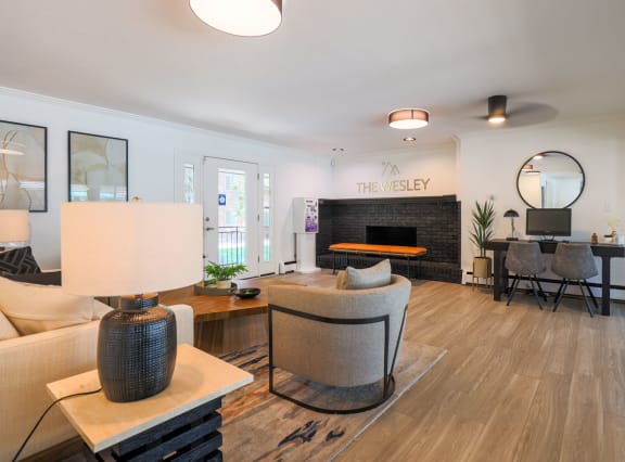 a living room with a couch and a chair and a fireplace at The Wesley Apartments, Denver, CO 80222