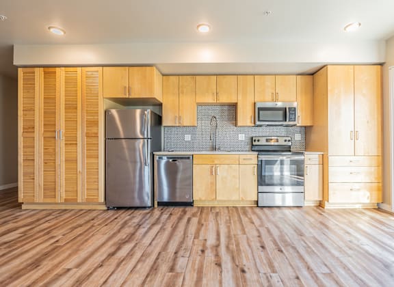 A kitchen with wooden cabinets and stainless steel appliances.