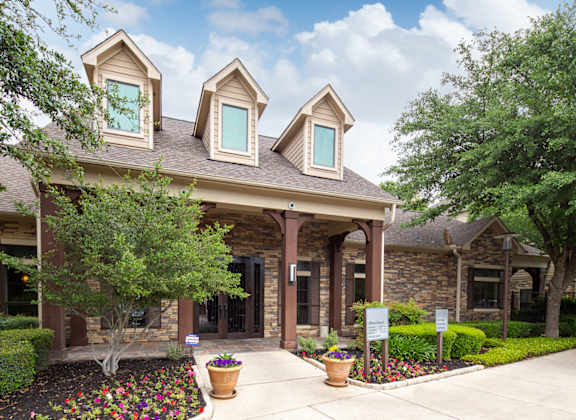 a home with a walkway in front of it