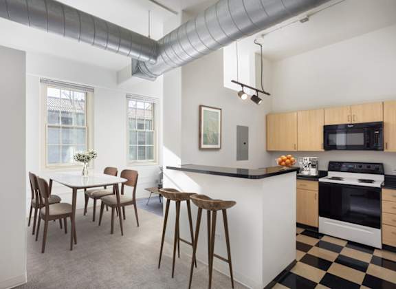 A kitchen with a black and white checkered floor.