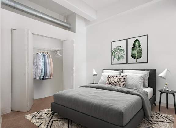 A bedroom with a large bed and a wardrobe.