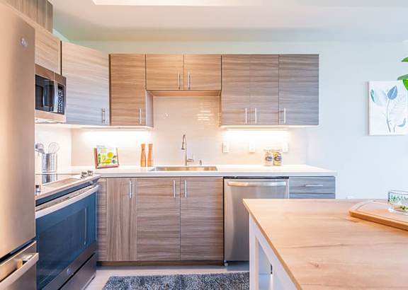 a kitchen with wooden cabinets and stainless steel appliances at Second & B Street, San Rafael, 94901