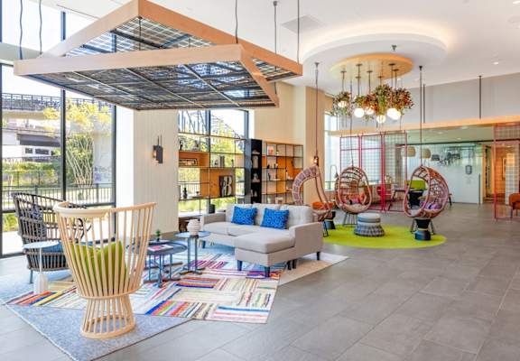 the lobby of a library with furniture and a large window at Coda at Bryant Street, Washington, DC 20002
