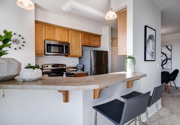 a kitchen with a large island with a granite countertop