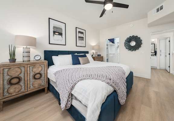 a bedroom with a large bed and a ceiling fan
