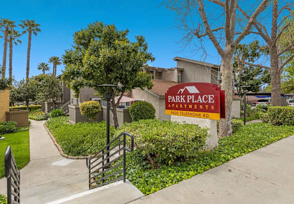A sign for Park Place Apartments is in front of a building.