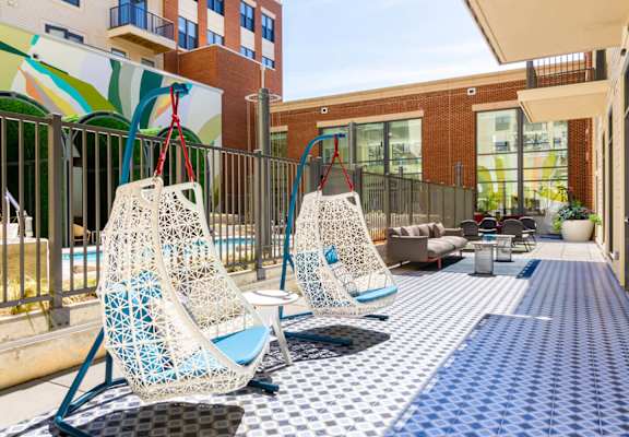 A patio with two chairs and a table.