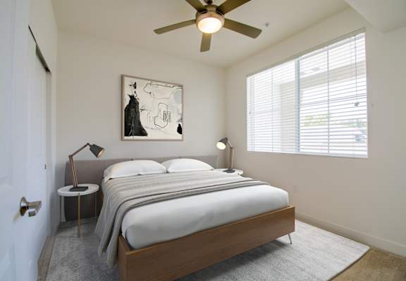 a bedroom with a bed and a ceiling fan