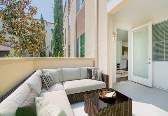 a patio with a couch and a coffee table