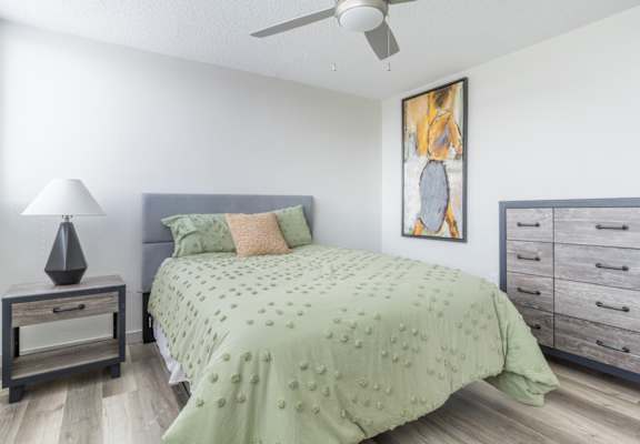 a bedroom with a bed and dresser