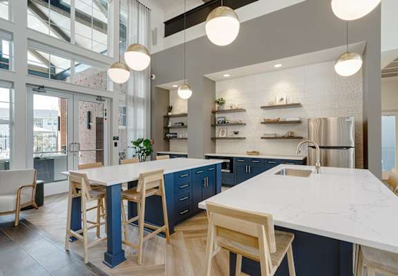a large kitchen with blue cabinets and a white counter top