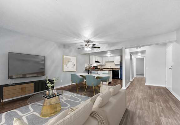 A living room with a television, a sofa, and a coffee table.