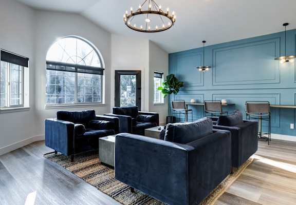 a living room with blue walls and a chandelier