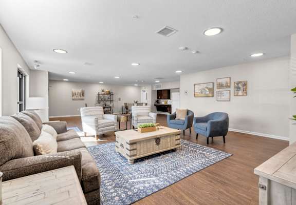 a living room with couches chairs and a coffee table