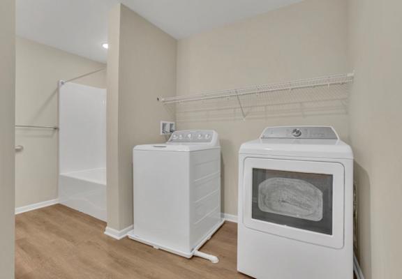 A kitchen with a white fridge, a white oven, and a white microwave.