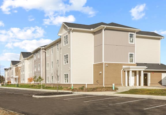 a row of new apartment buildings in a parking lot