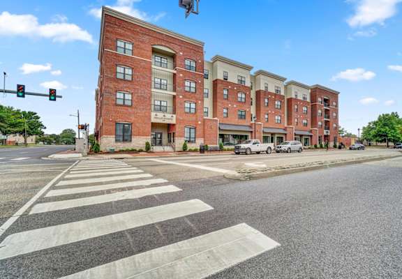 a building on a street corner with a crosswalk in front of it