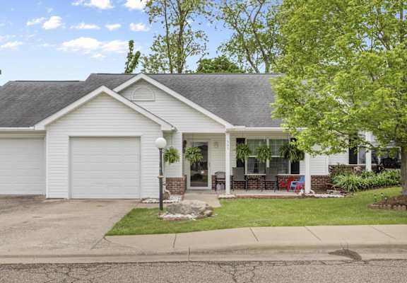 a white house with a lawn and a white garage door